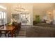Spacious dining room featuring a modern chandelier, stylish furniture, hardwood floors, and an open floor plan at 9 Knob Oak Dr, Henderson, NV 89052