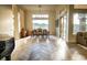 Bright dining room features beautiful hardwood floors, chandelier, large windows with backyard view, and ample lighting at 9 Knob Oak Dr, Henderson, NV 89052
