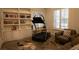 Exercise room with built in book shelves and workout equipment near the window at 9 Knob Oak Dr, Henderson, NV 89052