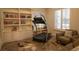 Exercise room with built in book shelves and workout equipment near the window at 9 Knob Oak Dr, Henderson, NV 89052