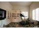 Well-lit exercise room with large built-in shelves, treadmill and comfortable seating at 9 Knob Oak Dr, Henderson, NV 89052