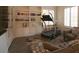 Well-lit home gym equipped with a treadmill, built-in bookshelves, and a comfortable sitting area at 9 Knob Oak Dr, Henderson, NV 89052
