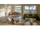 Bright, open-concept living room with hardwood floors, large windows showcasing the view, and elegant furnishings at 9 Knob Oak Dr, Henderson, NV 89052
