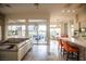 Open living space with tile floors, a view to the patio, and breakfast bar seating at 9 Knob Oak Dr, Henderson, NV 89052