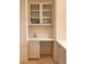 This wet bar features a sink, stone counter, and glass cabinets at 9 Knob Oak Dr, Henderson, NV 89052