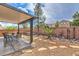 Enjoy the spacious backyard with a covered patio, hot tub, desert landscaping, and pavers at 9005 Semillon St, Las Vegas, NV 89148