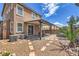 View of the home's backyard with a covered patio, desert landscaping and stepping stone pavers at 9005 Semillon St, Las Vegas, NV 89148