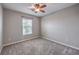 Bedroom featuring neutral walls and carpet, ceiling fan, and a window with blinds at 9005 Semillon St, Las Vegas, NV 89148