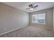 Bedroom with neutral carpet and walls, ceiling fan, and a window with blinds at 9005 Semillon St, Las Vegas, NV 89148