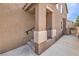 Side entrance with steps, small porch, and metal handrail, plus an adjacent walkway to a gated area at 9005 Semillon St, Las Vegas, NV 89148