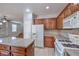 Spacious kitchen boasts a functional island, white appliances, and wood cabinets at 9005 Semillon St, Las Vegas, NV 89148