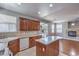 Modern kitchen with wood cabinetry, granite island, and stainless steel dishwasher at 9005 Semillon St, Las Vegas, NV 89148