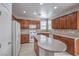 Well-lit kitchen features wood cabinets, granite countertops, and a functional island at 9005 Semillon St, Las Vegas, NV 89148