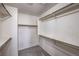 Spacious walk-in closet with carpet flooring and multiple shelves and rods for ample storage at 9005 Semillon St, Las Vegas, NV 89148