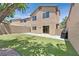 Enclosed backyard features artificial grass, a patio and modern stucco and siding at 9105 White Eyes Ave, Las Vegas, NV 89143