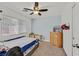 Comfortable carpeted bedroom with a window and a ceiling fan, complete with a dresser and closet at 9105 White Eyes Ave, Las Vegas, NV 89143