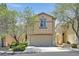 Charming two-story home featuring desert landscaping, neutral colors, and an attached two-car garage at 9105 White Eyes Ave, Las Vegas, NV 89143