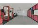 Spacious garage with speckled epoxy flooring, storage cabinets, and weightlifting equipment, perfect for fitness enthusiasts at 9105 White Eyes Ave, Las Vegas, NV 89143