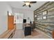 Cozy home office featuring wood paneling, natural light, and ceiling fan at 9105 White Eyes Ave, Las Vegas, NV 89143