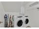 Bright laundry room features a washer and dryer, shelving, and cleaning supplies at 9105 White Eyes Ave, Las Vegas, NV 89143
