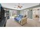 Open living room with a sliding door to the backyard and comfortable sofa at 9105 White Eyes Ave, Las Vegas, NV 89143