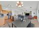 Spacious living room with modern light fixtures, open floor plan, neutral walls, and an eat-in kitchen at 9105 White Eyes Ave, Las Vegas, NV 89143