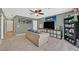 Cozy living room with a large TV, comfortable sofa, and sport themed decor at 9105 White Eyes Ave, Las Vegas, NV 89143