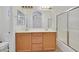 Bright bathroom features double sinks, a large mirror, and a glass shower door at 9105 White Eyes Ave, Las Vegas, NV 89143