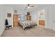 Spacious main bedroom features a ceiling fan, carpet, and an ensuite bathroom at 9105 White Eyes Ave, Las Vegas, NV 89143