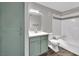 Bathroom with tub-shower combo, modern vanity with a marble countertop, linen closet, and wood-look flooring at 950 Seven Hills Dr # 124, Henderson, NV 89052