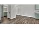 Light-filled bedroom features mirrored closet doors, wood-look flooring, and access to ensuite bathroom at 950 Seven Hills Dr # 124, Henderson, NV 89052
