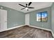 Bedroom with wood-look laminate flooring, ceiling fan, neutral paint and natural light at 950 Seven Hills Dr # 124, Henderson, NV 89052