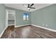 Comfortable bedroom features wood-look floors, a ceiling fan, and a bright window at 950 Seven Hills Dr # 124, Henderson, NV 89052