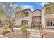 Charming condo featuring a landscaped front yard and a two-story building facade, with easy stair access to the upper units at 950 Seven Hills Dr # 124, Henderson, NV 89052
