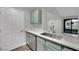 Modern kitchen featuring a large sink, quartz countertops and stainless steel dishwasher at 950 Seven Hills Dr # 124, Henderson, NV 89052