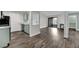 Open-concept living room boasts wood-style flooring, modern fireplace, and access to the balcony at 950 Seven Hills Dr # 124, Henderson, NV 89052
