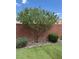 Backyard with fresh green artificial turf and rock landscaping, framed by a brick privacy wall at 9853 Bangalore Ct, Las Vegas, NV 89148