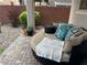 Back patio featuring brick pavers, rock landscaping, privacy wall and comfortable outdoor seating at 9853 Bangalore Ct, Las Vegas, NV 89148
