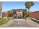 Inviting backyard with pergola, lounge seating, yoga space, desert landscaping, and privacy fence at 9853 Bangalore Ct, Las Vegas, NV 89148