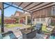Backyard offers a covered patio, putting green, lounge seating, desert landscaping, and privacy fence at 9853 Bangalore Ct, Las Vegas, NV 89148