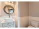 Stylish powder room with modern vanity, round mirror, and wainscoting at 9853 Bangalore Ct, Las Vegas, NV 89148
