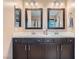Elegant bathroom with a double sink vanity and framed mirrors at 9853 Bangalore Ct, Las Vegas, NV 89148