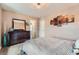 Cozy bedroom featuring a dark dresser, an accent mirror and artwork at 9853 Bangalore Ct, Las Vegas, NV 89148