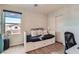Bright bedroom features modern laminate flooring, a daybed, and paneled walls at 9853 Bangalore Ct, Las Vegas, NV 89148