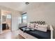 Bright bedroom features modern laminate flooring, a daybed, and an ensuite bathroom at 9853 Bangalore Ct, Las Vegas, NV 89148