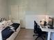 Bright bedroom features modern laminate flooring, a daybed, closet and desk at 9853 Bangalore Ct, Las Vegas, NV 89148