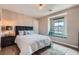 Serene bedroom with a cozy window seat and a decorative ceiling light at 9853 Bangalore Ct, Las Vegas, NV 89148