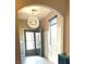 Bright entryway featuring wainscoting, a modern light fixture, and a blue accent cabinet at 9853 Bangalore Ct, Las Vegas, NV 89148