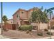 Lovely exterior corner with manicured landscaping, stone accents, and two-car garage at 9853 Bangalore Ct, Las Vegas, NV 89148