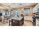 Open-concept kitchen with a central island, dining area, and access to the backyard at 9853 Bangalore Ct, Las Vegas, NV 89148